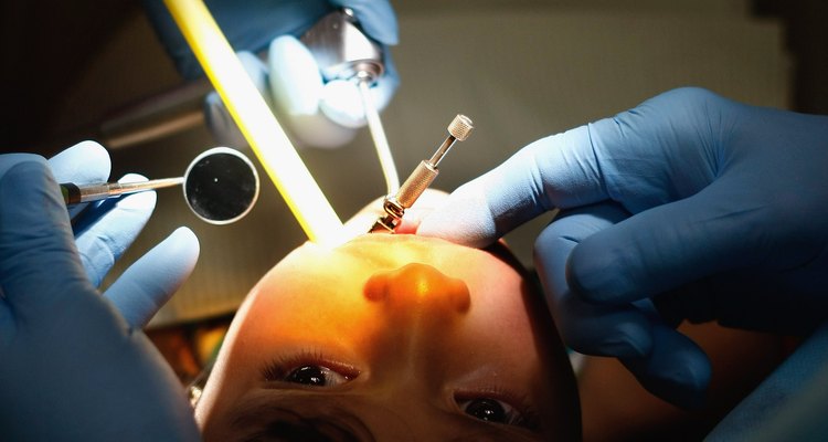 A dentist replaces the tooth structure with an artificial material to restore the appearance and function of the tooth.