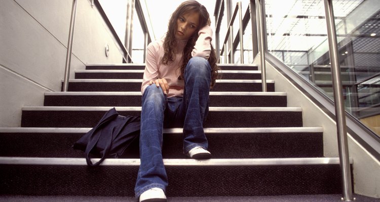Depressed teen sitting on steps
