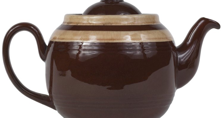 Remove a stuck teapot lid with water and oil.
