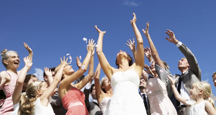 Bride Throwing Bouquet For Guests To Catch