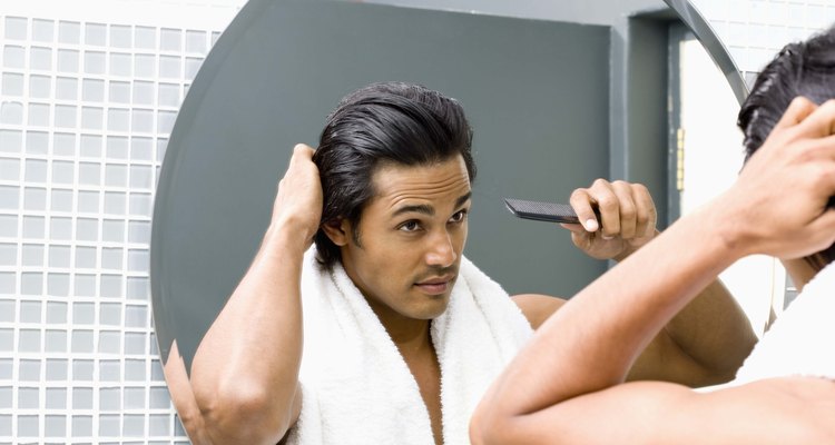 Man combing hair in mirror