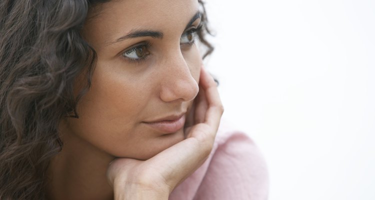 Young woman resting chin in hand, close-up