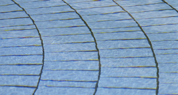 Attach concrete pavers with construction adhesive so they'll remain in place for years.