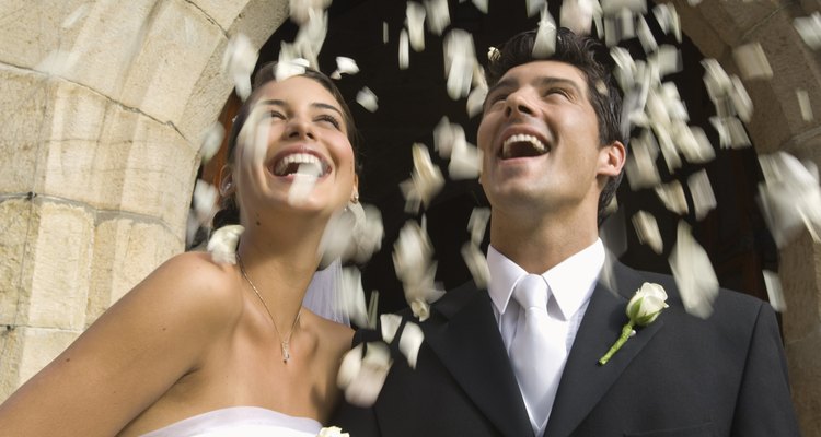 Flower petals over bride and groom