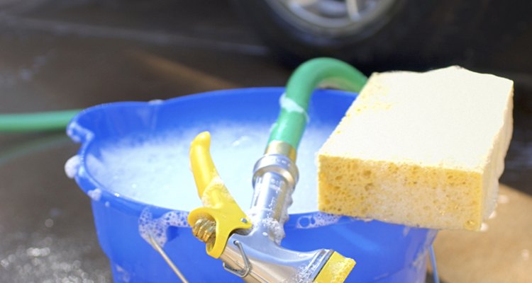 Una solución de algún jabón o champú especial limpiará el exterior de tu coche así como las superficies interiores, incluyendo los tapetes del piso.