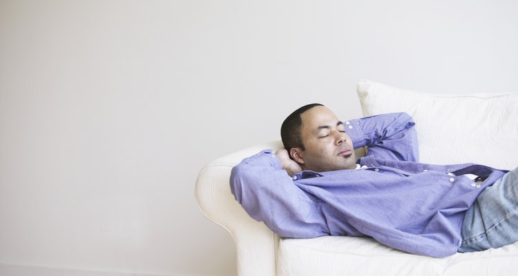 African man sleeping on sofa