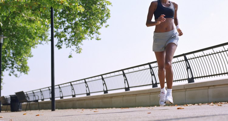 Woman running on embankment, low angle view