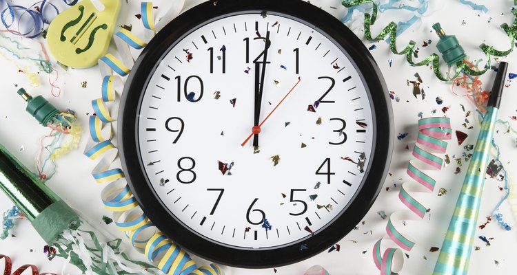 Clock showing midnight surrounded by confetti and ribbons