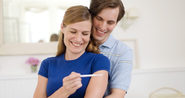 Happy man and woman with pregnancy test