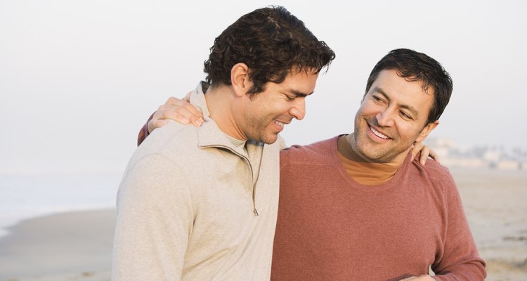 Hispanic friends walking on beach