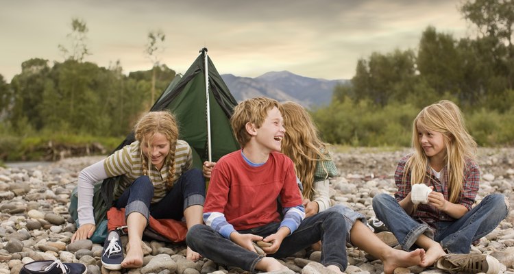 Brother and sisters playing in small tent