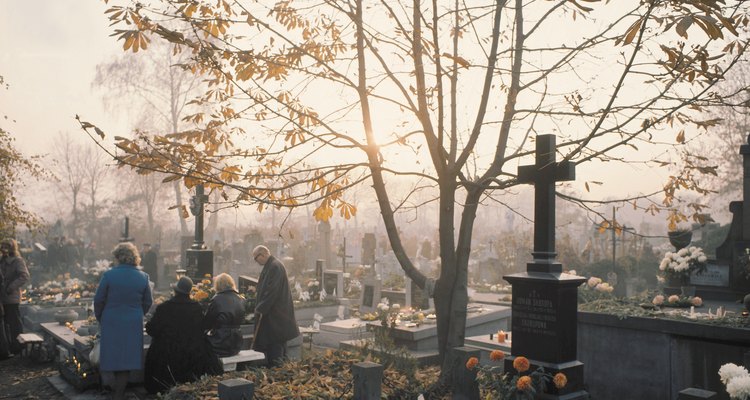 People at burial plot in cemetery