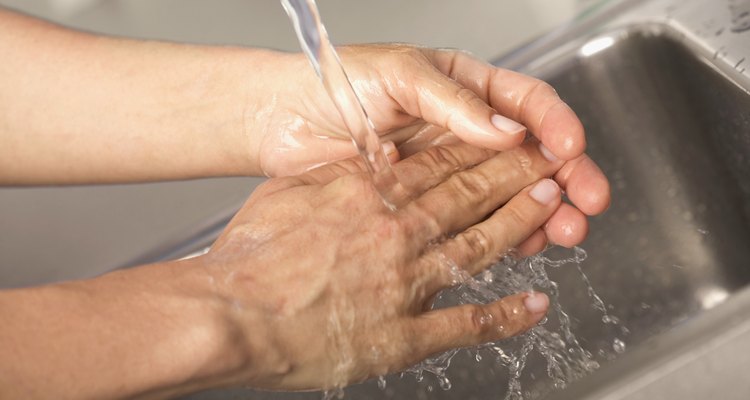 Healthcare worker washing hands in hospital