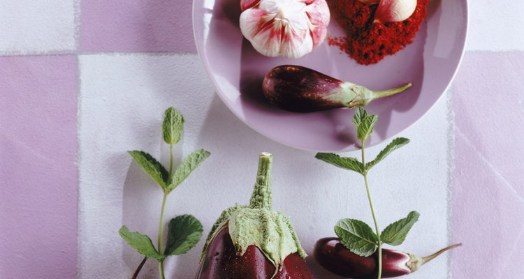 Garlic bulb in plate with eggplant, directly above