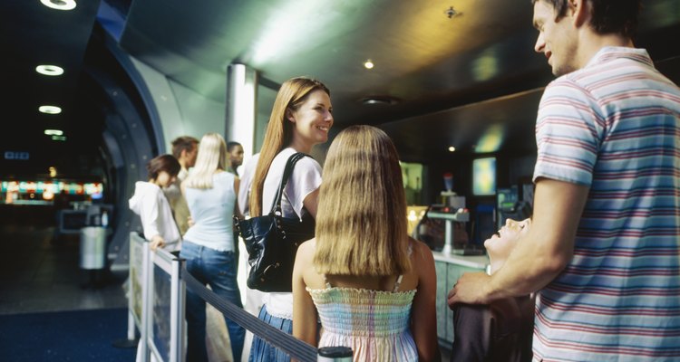 Large group of people standing in a queue inside a cinema