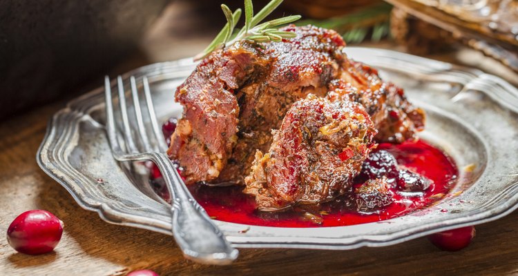 Freshly served venison with cranberries and rosemary