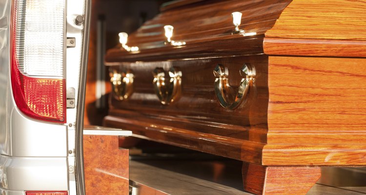 Funeral with coffin in hearse