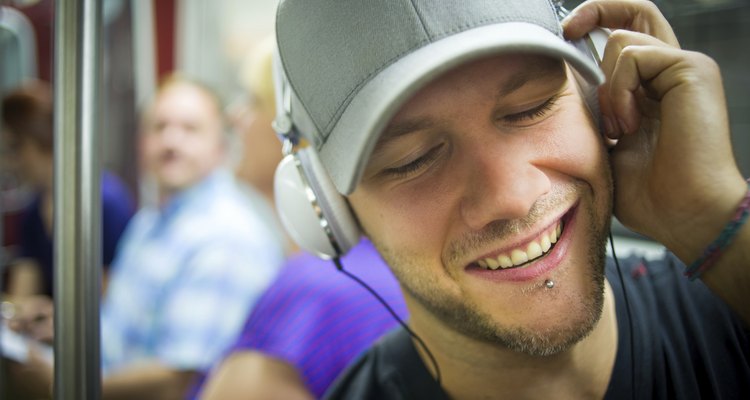 Man with headphones rocking out during subway commute