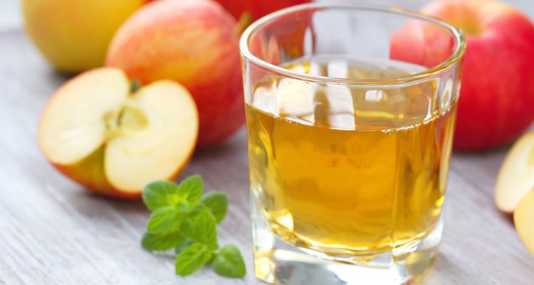 Apple juice and apples on the table