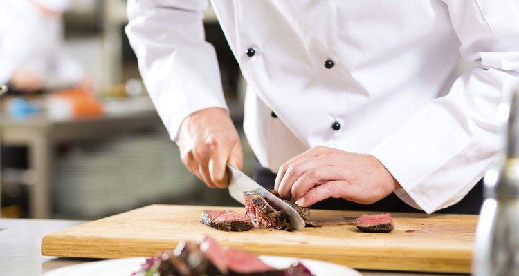 Chef in restaurant kitchen preparing food