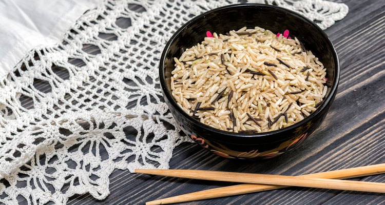 Unpolished rice on wooden background