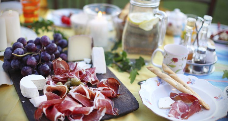 Prosciutto with cheese and grapes on a picnic table