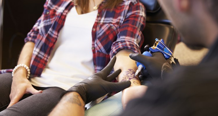 Close Up Of Woman Sitting In Chair Having Tattoo
