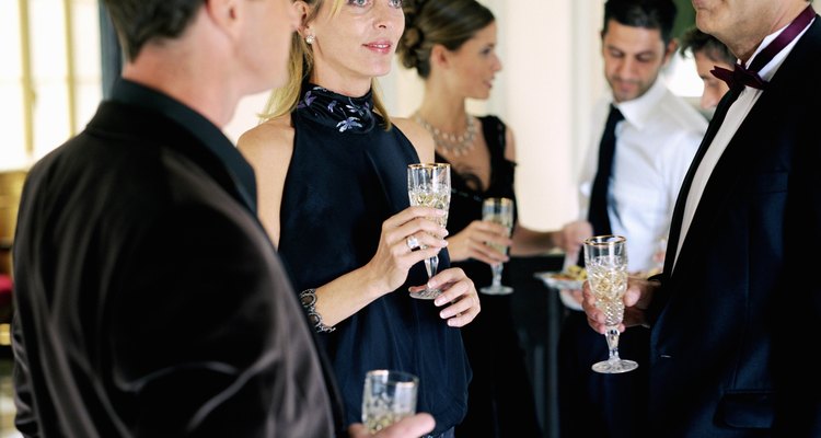 Group of people wearing formal attire, holding champagne glasses