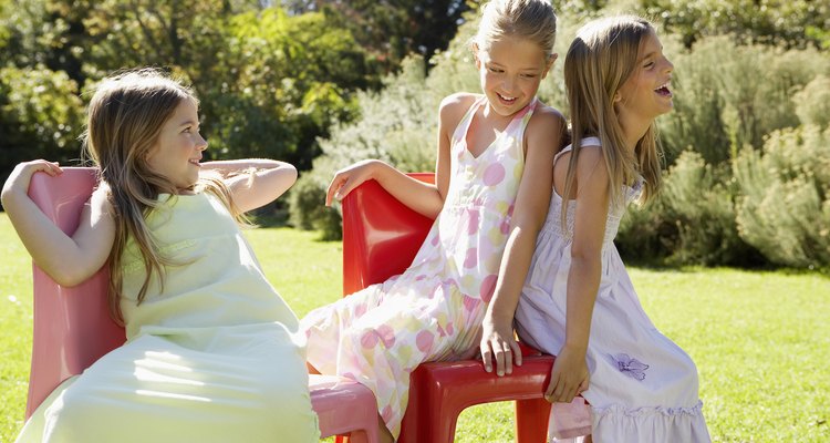Three Girls Playing Musical Chairs in Garden