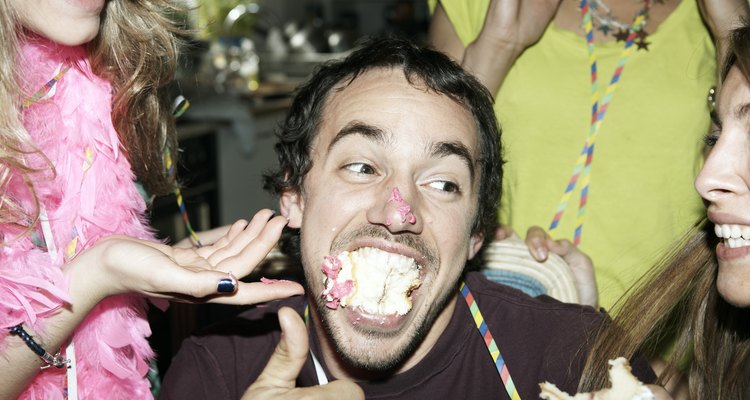 Man with his mouth full of cake