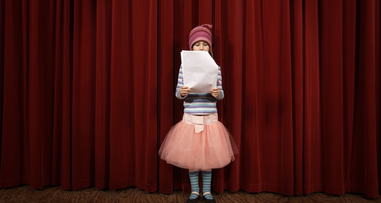 Girl (5-7) practicing lines on stage