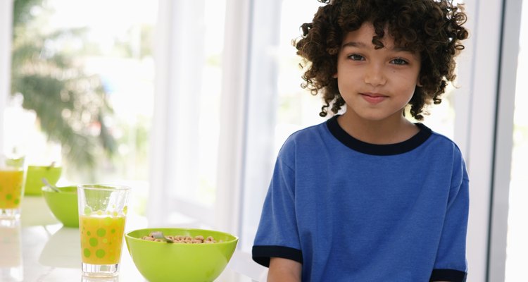 Boy (8-10) at breakfast table, portrait