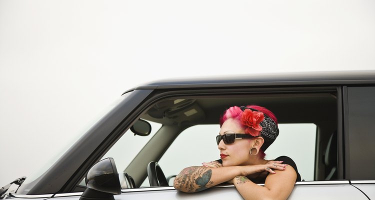 Tattooed Hispanic woman in car