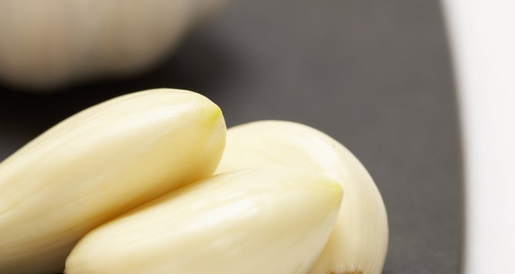 Garlic cloves and bulb on cutting board