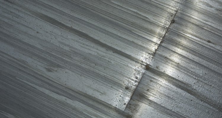 Distressed metal appears worn, aged and antique.