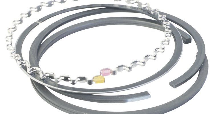 Piston rings seal the combustion chamber, maintaining compression.