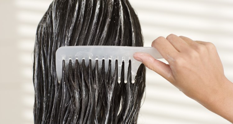 Woman combing her wet hair