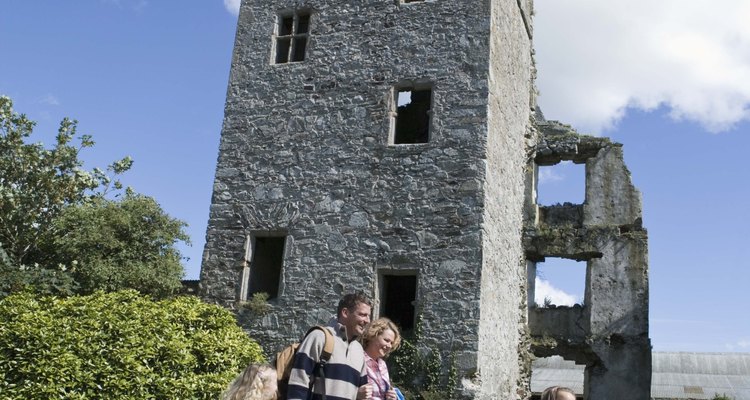 Family sightseeing in Ireland park with ruins of tower
