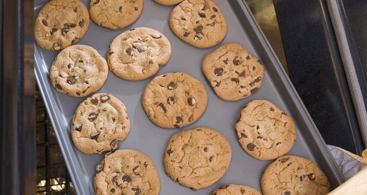 Woman removing cookies from oven