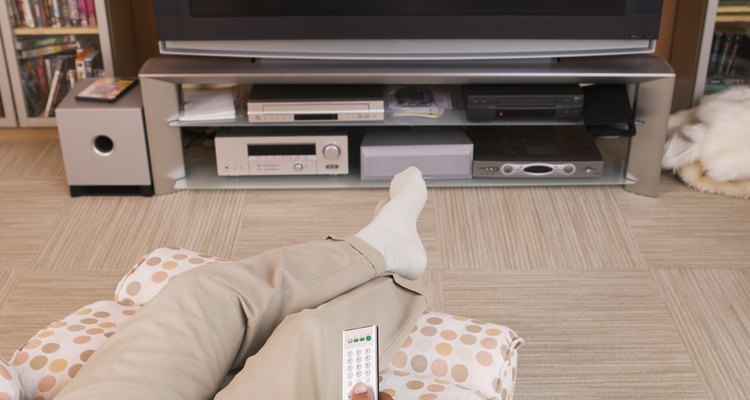 Use buttons or a lever to adjust a reclining chair.