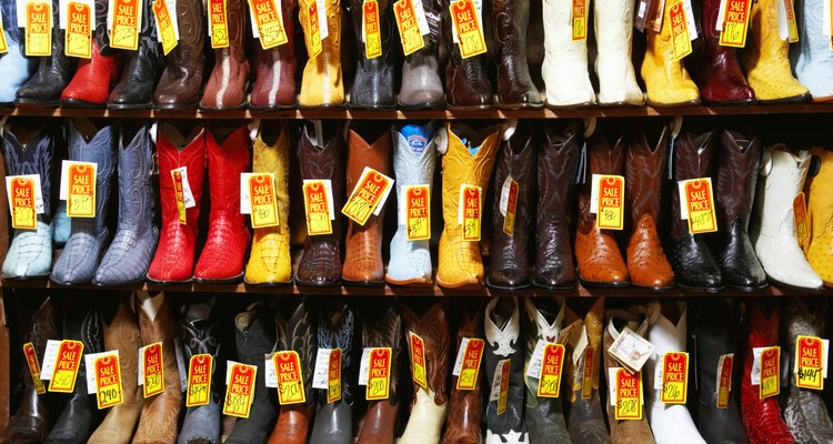 Rack of cowboy boots in shoe store, full frame