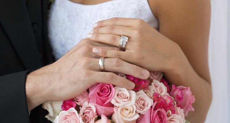 Close-up of two people's hands wearing wedding rings