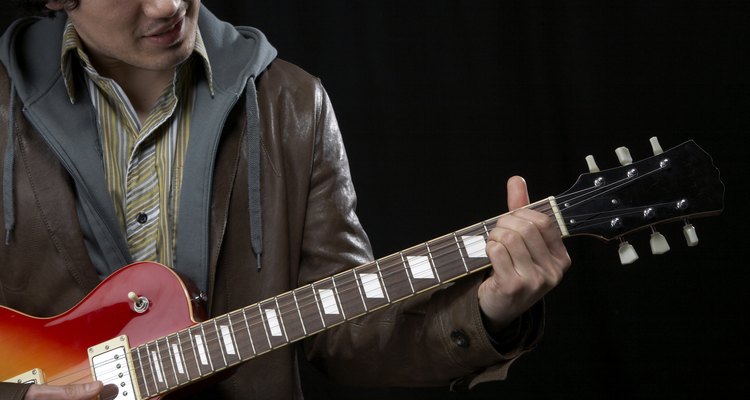 Shot in the UK, man playing a guitar