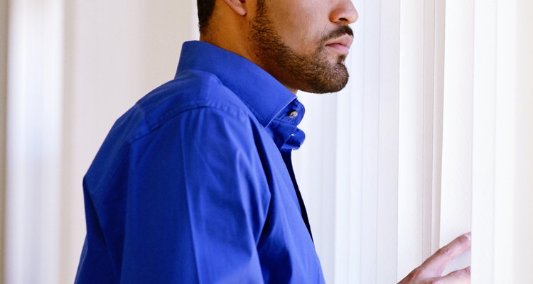 Man looking out window