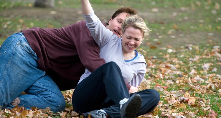 Couple playing football in park