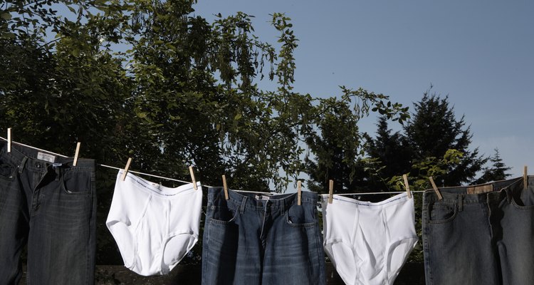Jeans and men's underwear hanging from clothesline outdoors