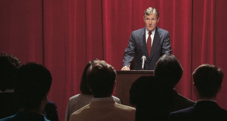 Businessman giving speech at podium