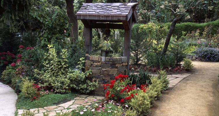 Convert an attractive garden well into a raised plant bed.