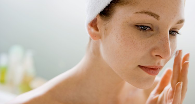 Woman using moisturizing cream