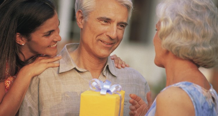 Daughter and wife giving man a gift